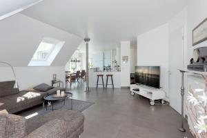 a living room with a couch and a tv at Ferienwohnung Rafaela in Zinnowitz