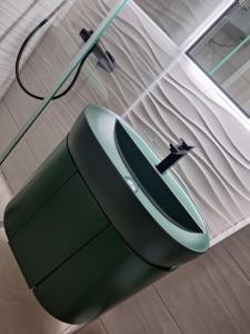 a green mouse with a hose attached to a wall at Apartman Vera in Prijedor +23 photos