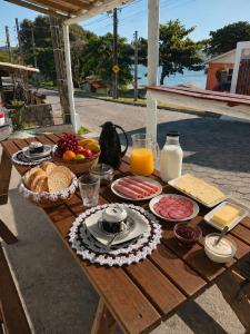 a picnic table with food and drinks on it at paraiso da lagoa in Imbituba