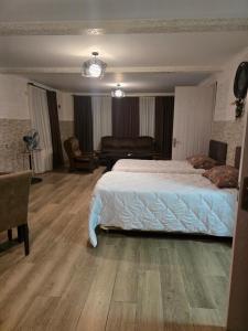 a bedroom with a bed and a living room at Guest House KATO in Poti