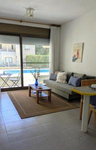 a living room with a couch and a table at Gaviotas piscina comunitaria in Calafat