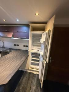 an empty kitchen with an empty refrigerator in it at Echelon Executive suite 1 in Bradford