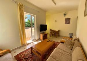 a living room with a couch and a table at Beach Walk Apartment with Private Garden & Wifi in Grand-Baie