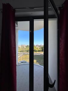 an open door with a view of a balcony at Sar Hotel, Velipojë in Velipojë