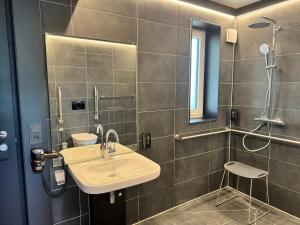 a bathroom with a sink and a shower at ESB Hotel by WMM Hotels in Windischeschenbach +10 photos