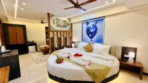 a bedroom with a large bed with towels on it at Hotel Aventus Grand in Indore +67 photos