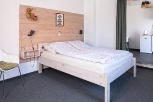 a bed in a room with a wooden headboard at Studio apartment LoSt in Ogulin