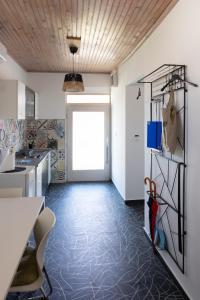 a kitchen with a tile floor and a doorway at Studio apartment LoSt in Ogulin