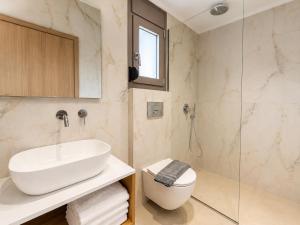 a bathroom with a sink and a glass shower at B Cozy Apartments in Limenaria +96 photos