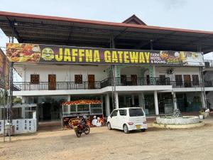 a white van parked in front of a building at Jaffna Gateway Hotel and Restaurant in Kanakarayankulam