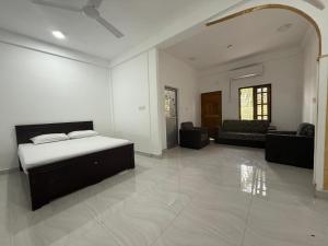 a bedroom with a bed and a living room at Jaffna Gateway Hotel and Restaurant in Kanakarayankulam