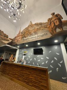 a restaurant with a sign on the wall and a bench at Baan Phu Place in Ban Suan +96 photos