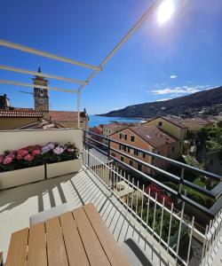 a balcony with a table and a view of a city at Riviera Feeling - Ospedaletti in Ospedaletti