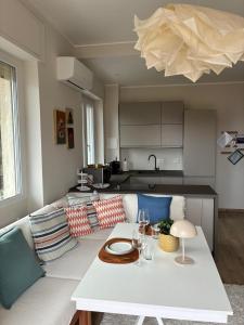 a living room with a couch and a table at Riviera Feeling - Ospedaletti in Ospedaletti