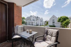 a patio with a table and chairs on a balcony at Appartement Agnes in Westerland