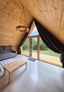 a room with a bench and a large window at Кольсай Тау Оректы resort in Kurmenty