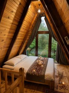 a bed in a room in a wooden house at Oce Bungalow in Ardeşen +24 photos