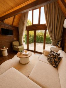 a living room with a couch and a large window at Oce Bungalow in Ardeşen