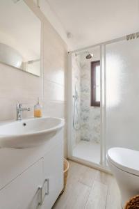 a white bathroom with a sink and a shower at Gabri's Home in Spello +63 photos
