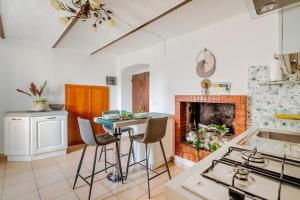 a kitchen with a table and chairs and a fireplace at Gabri's Home in Spello