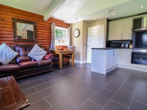 a living room with a couch and a table at The Red in St Asaph