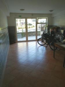 a room with a bunch of bikes parked on a tile floor at Rooms Izola in Izola