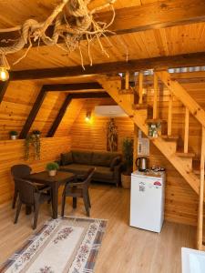 a living room with a couch and a table at Oce Bungalow in Ardeşen