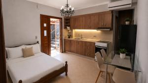 a bedroom with a bed and a table and a kitchen at Harmony apartment near Dassia, Ipsos in Ipsos