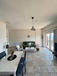 a living room with a couch and a table at Stergios Apartment Evdilos Ikaria in Evdilos