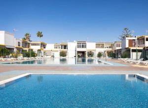 a large swimming pool in the middle of a resort at Rentdragoana in Costa Del Silencio