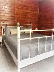a white bed in a room with a wooden wall at Rentdragoana in Costa Del Silencio +15 photos