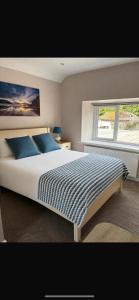 a bedroom with a large bed and a window at Grove house Dunleer in Dún Léire
