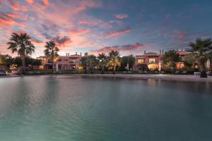 a large pool of water in front of some houses at Cascade Wellness Resort Lagos Algarve by Domes in Lagos