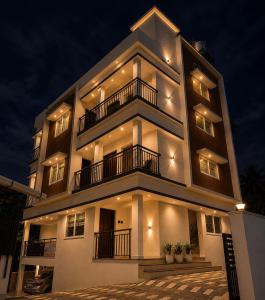 a large building with lights on it at night at JK Homes in Alwaye