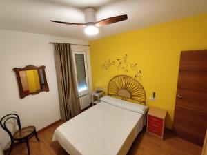 a bedroom with a bed and a ceiling fan at Casa Laureana in Ruidera