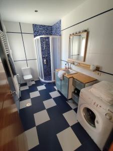 a bathroom with a washing machine and a sink at Casa Laureana in Ruidera +17 photos