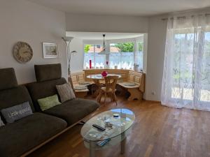 a living room with a couch and a table at Golfsuite Axel in Uttlau-Haarbach in Haarbach