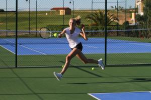 a young woman hitting a tennis ball with a racket at Cascade Wellness Resort Lagos Algarve by Domes in Lagos +67 photos
