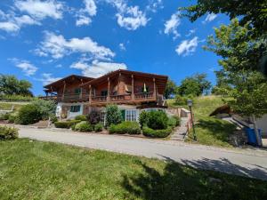 a log home with a wrap around porch at Golfsuite Axel in Uttlau-Haarbach in Haarbach