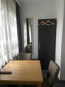 a dining room with a table and chairs and a door at Hotel Wandsbek Hamburg in Hamburg +22 photos