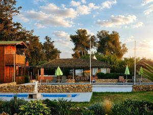 a resort with a pool and a building at Ferme Sacrée Nature in Ben Slimane