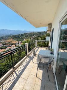a balcony with a table and chairs and a view at Stergios Apartment Evdilos Ikaria in Evdilos