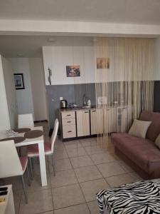 a living room with a couch and a table at Apartments Petrovic in Krimovice