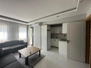 a living room with a couch and a table at Benan Apart Otel Didim in Didim