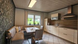 a kitchen with a couch and a table in a room at Auszeit Eifel Ihre private Auszeit zu zweit in Reuth
