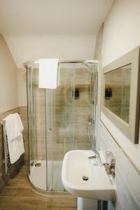 a bathroom with a glass shower and a sink at Caer Rhun Hall Hotel in Conwy +52 photos
