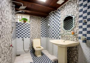 a bathroom with a toilet and a sink at Namali Guest House in Badulla +44 photos