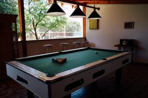 a billiard table in a room with a pool at Casa de Piatra in Porumbacu de Sus