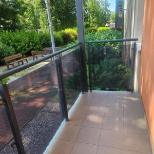 an open glass door with a view of a garden at Iglovia apartman in Spišská Nová Ves