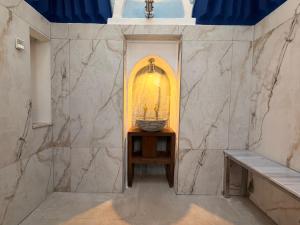 a bathroom with a sink and a basket on a table at Jivaeri Luxury Suites in Rhodes Town